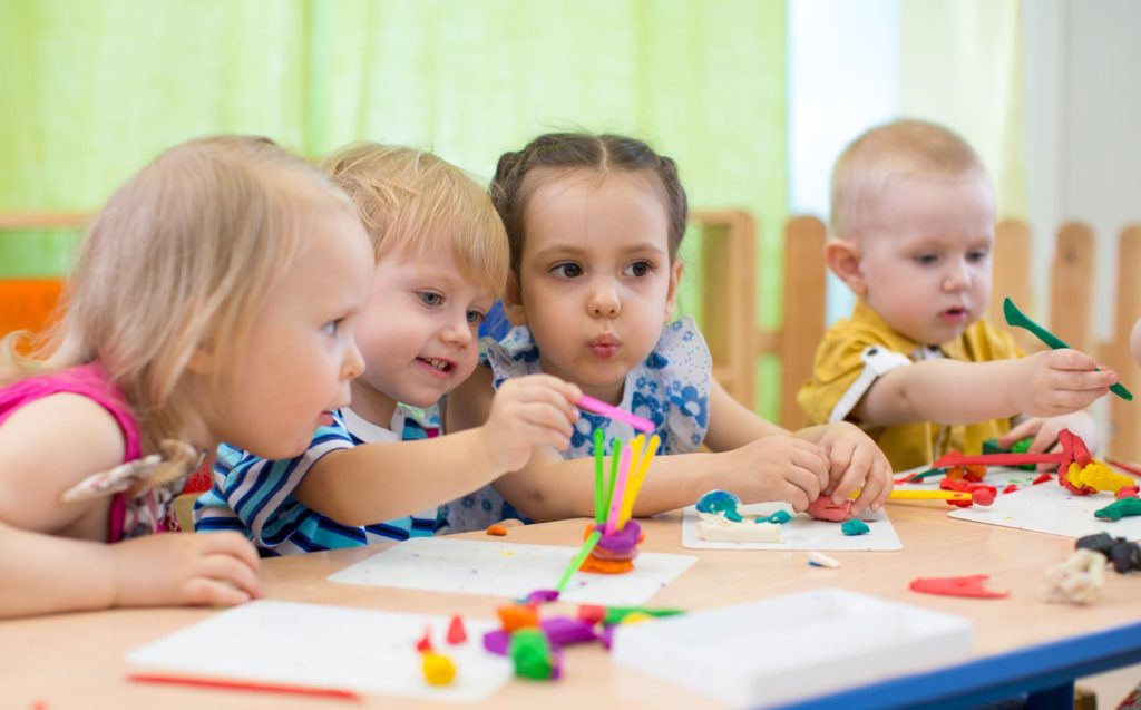 Little children playing together in the classroom